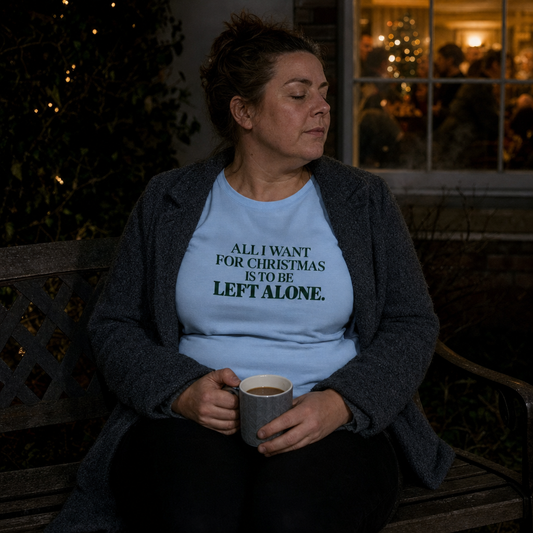 All I Want for Christmas Is to Be Left Alone tee worn alone on a garden bench on Christmas night