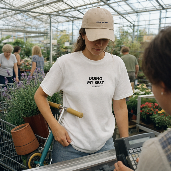 Doing My Best matching set: embroidered classic cap and T-shirt worn together at a garden centre
